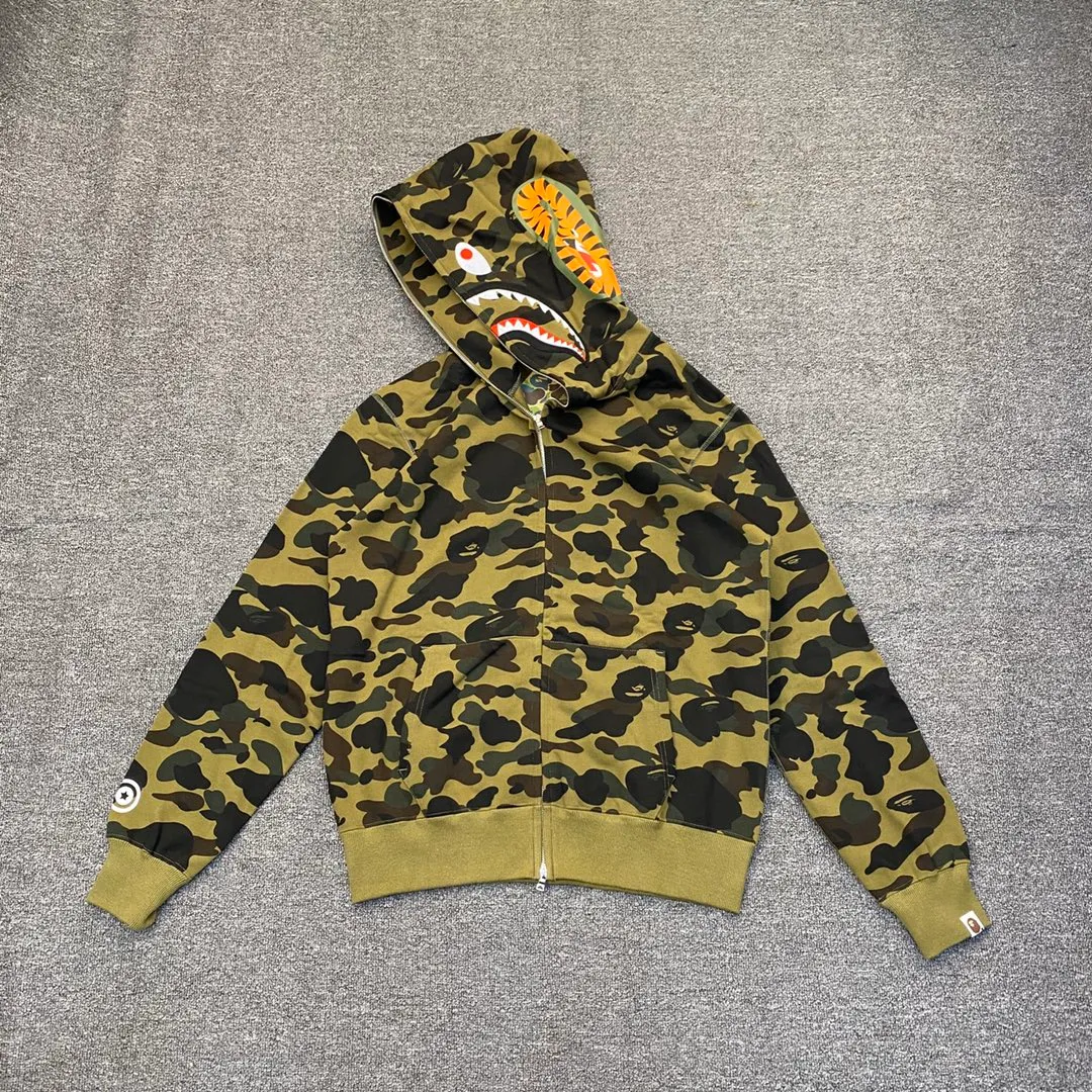 XX 121 BAPE 1ST CAMO SHARK FULL Classic counter model Camouflage shark hooded zipper sweatshirt Machine-printed camouflage Top-quality fabric Premium 1:1 replica Customized fabric Couple model: S—XXL [Camouflage yellow, Camouflage green, Camouflage red, Camouflage purple, Camouflage blue, Camouflage gray]